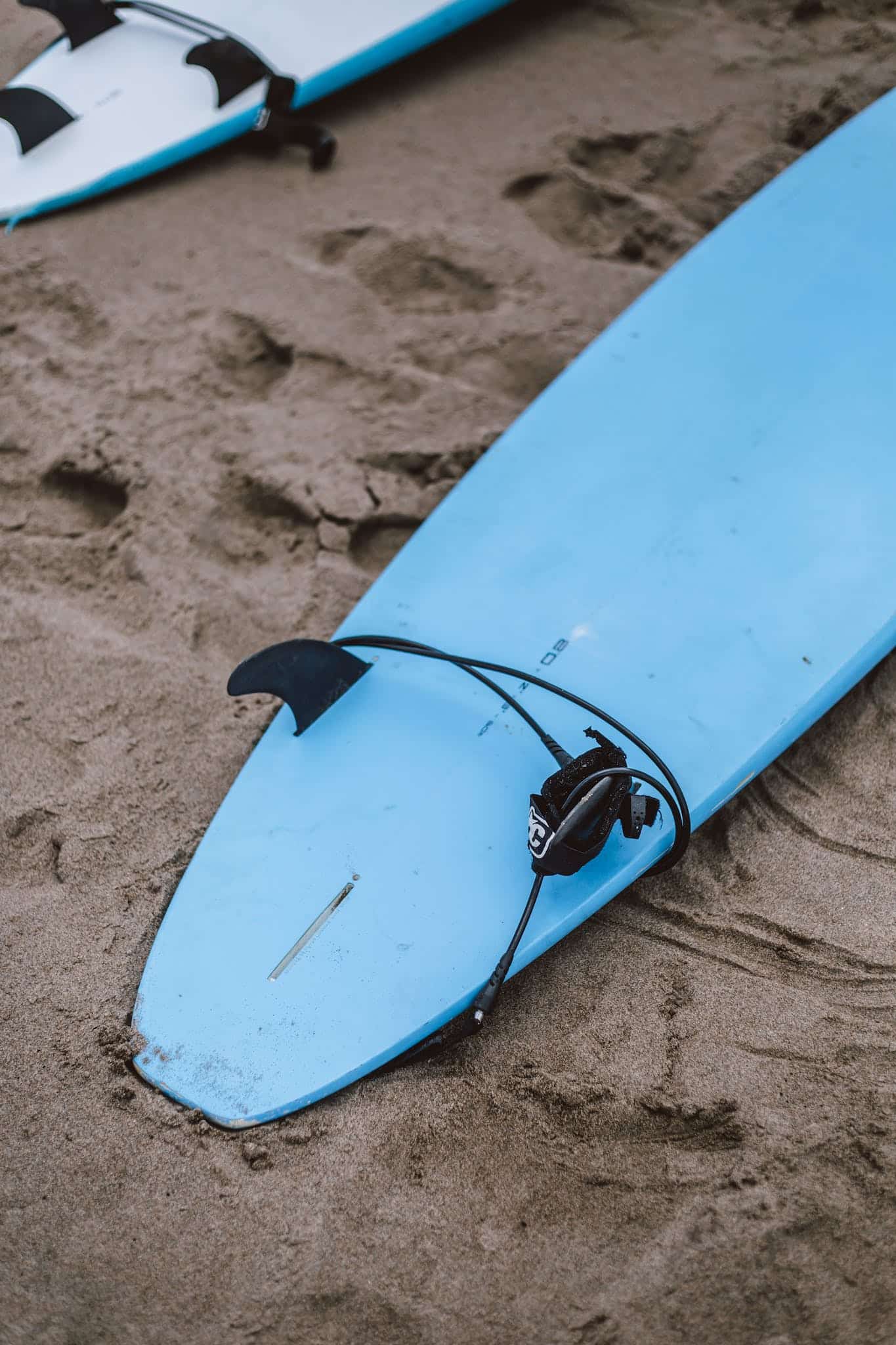 Blue Surfboard On Sand