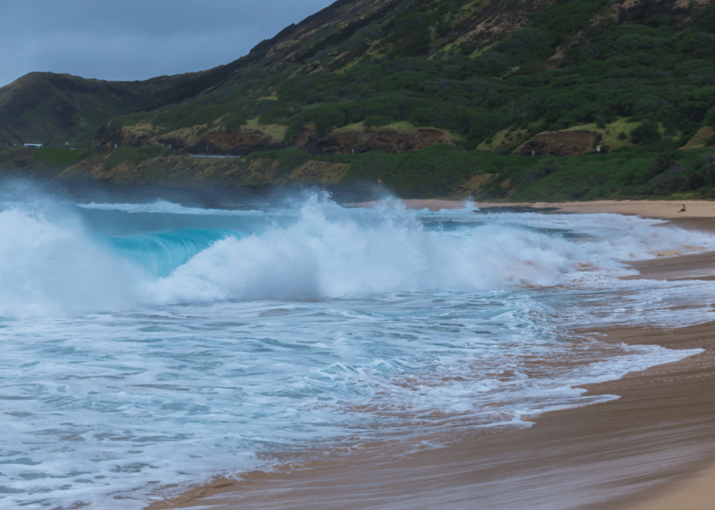 waves crashing onto a mountainous shoreline