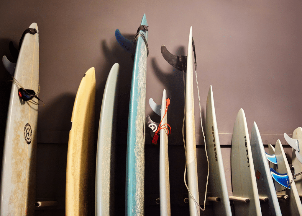 surfboards being stored on a rack