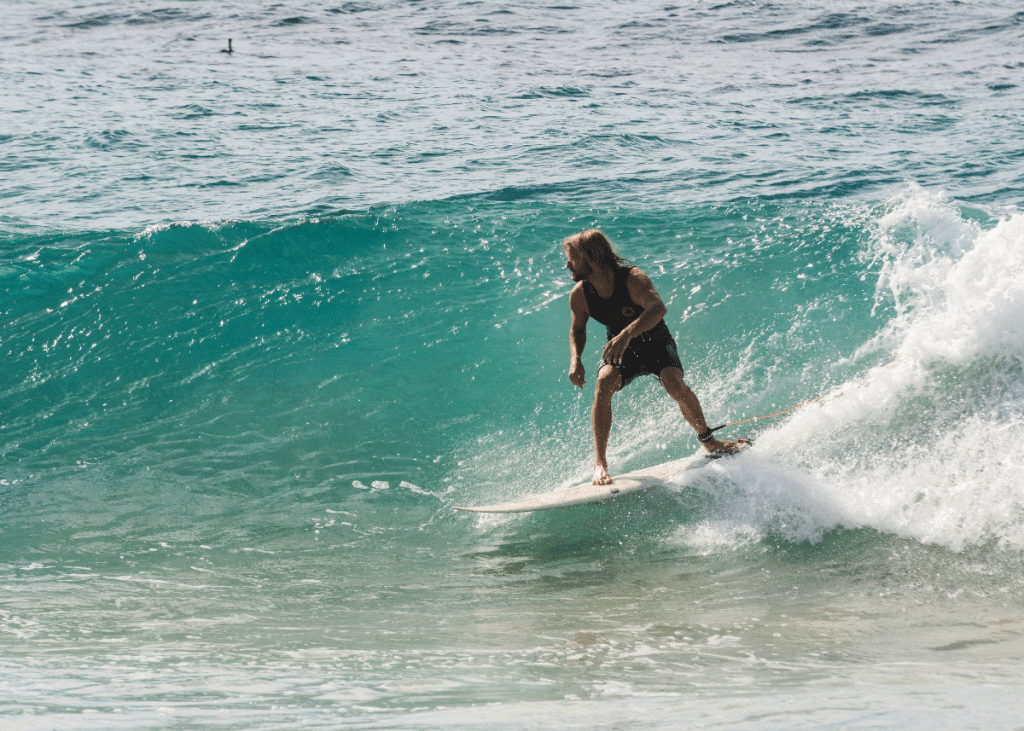 man riding a surfboard in a goofy foot stance