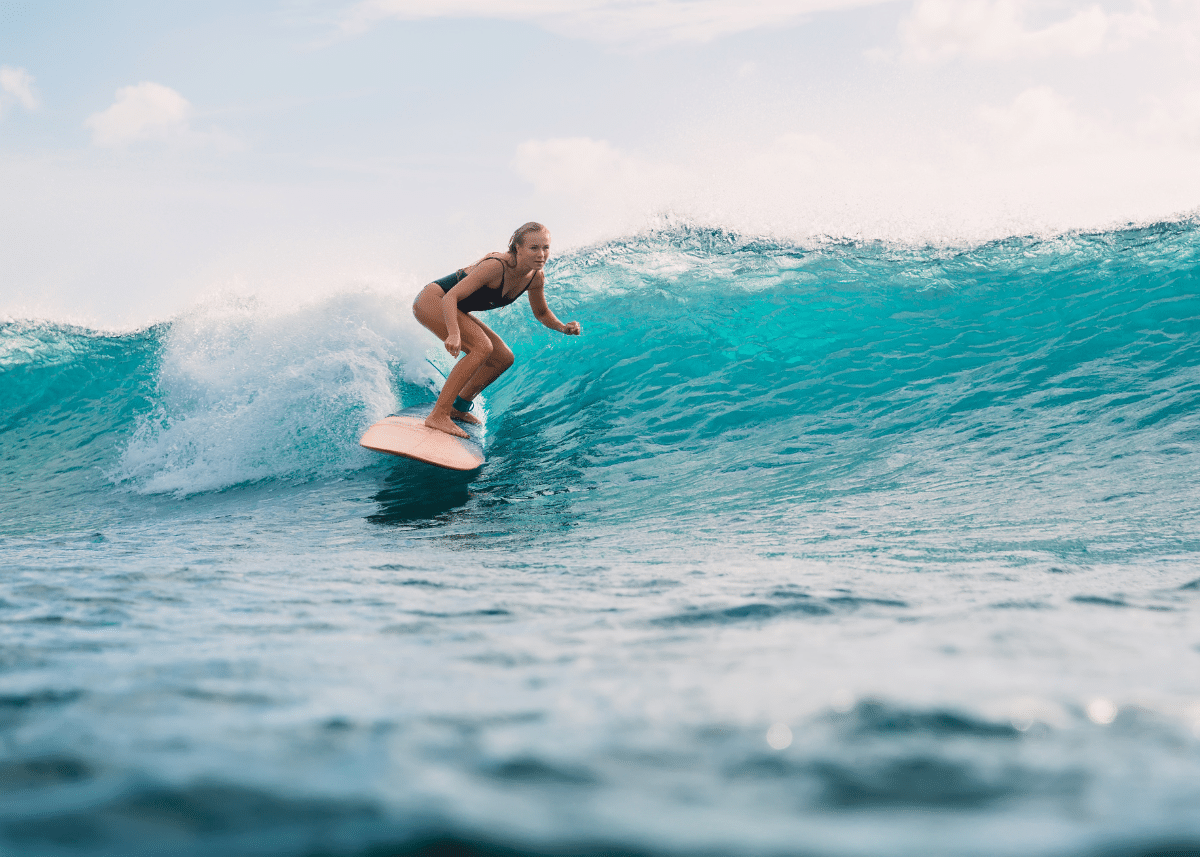woman riding a surfboard in a goofy foot stance
